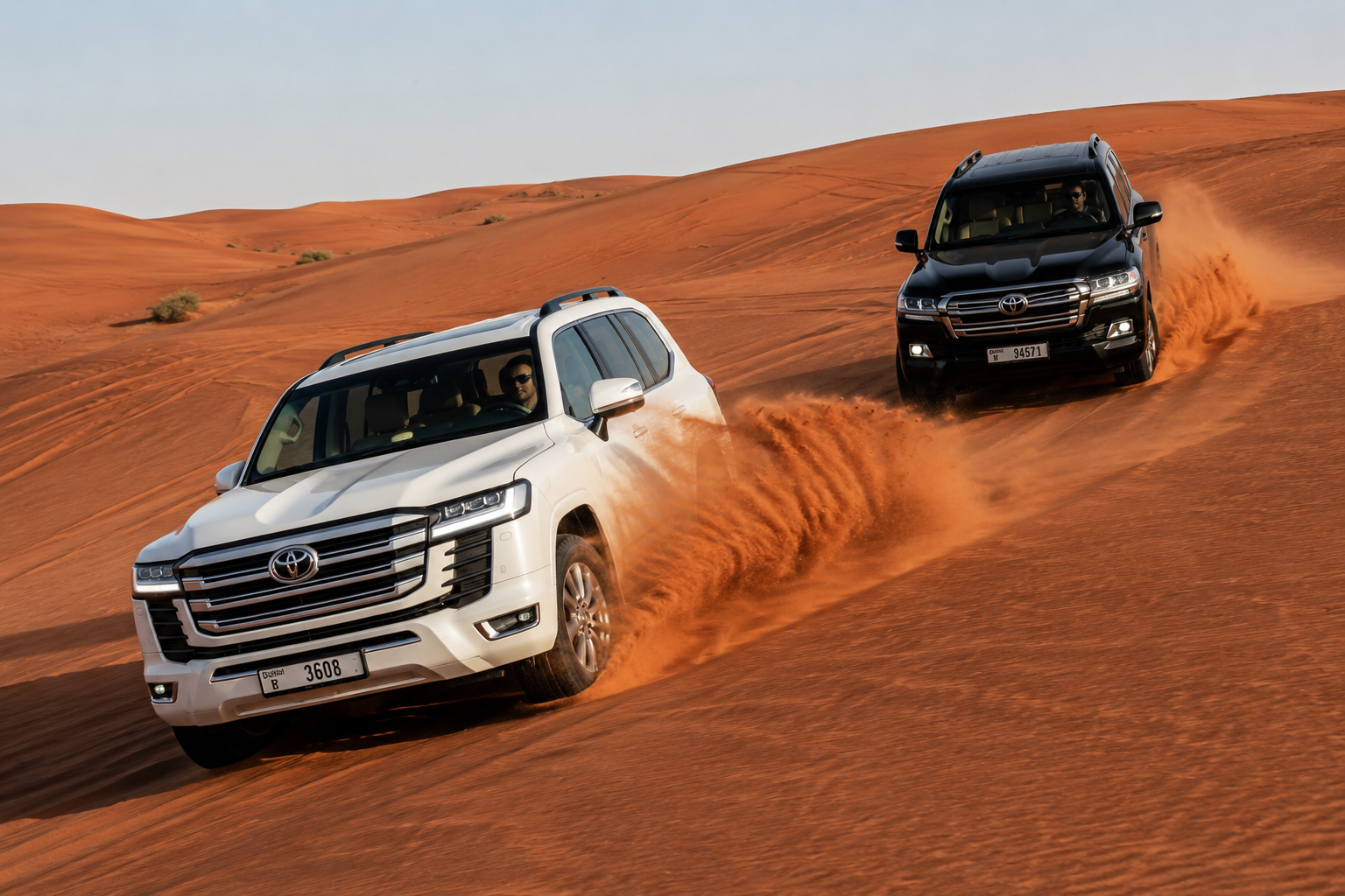 Shared 4x4 Land Cruisers during dune bashing session in the Lahbab red dunes, Dubai desert safari